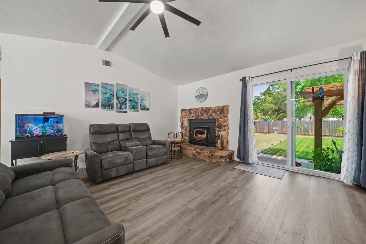 67 St Andrews Road Valley Springs, CA 95252 - Photo 9 of 58 a living room with furniture large window and a fireplace