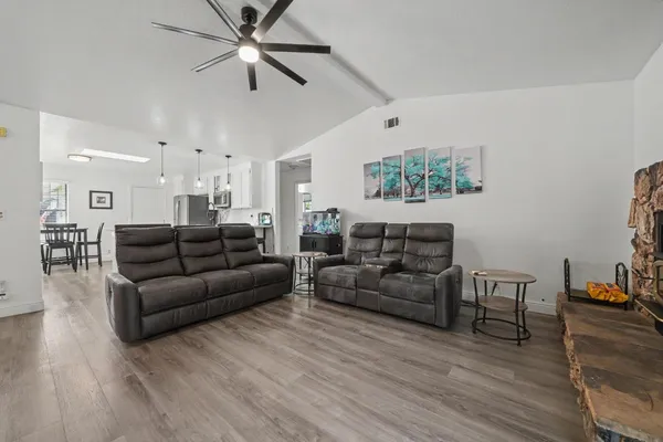 a living room with furniture and wooden floor