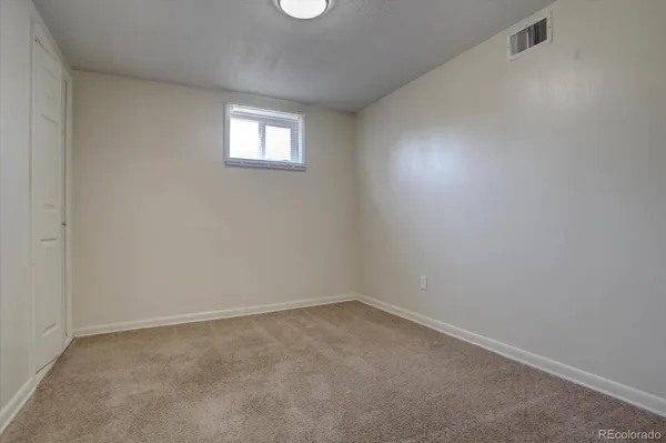 an empty room with windows and closet