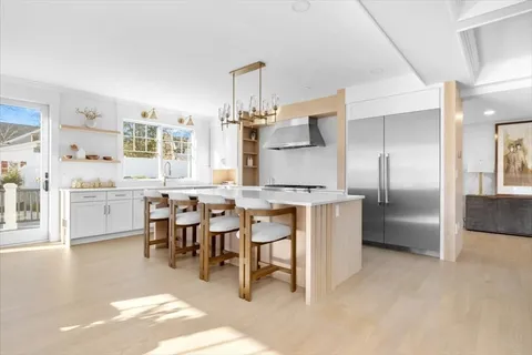a large kitchen with a table and chairs