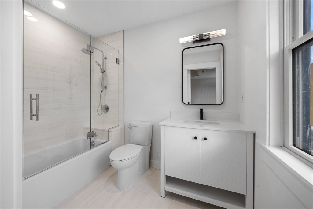 12 Daley Road Hingham, MA 02043 - Photo 19 of 32 a bathroom with a toilet a sink a mirror a shower and vanity