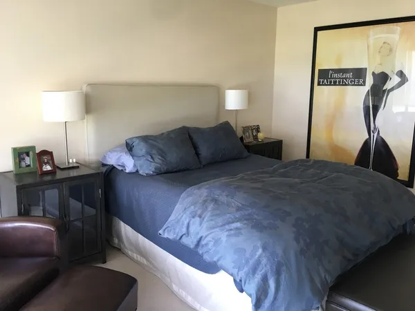 a living room with a bed furniture and a large window