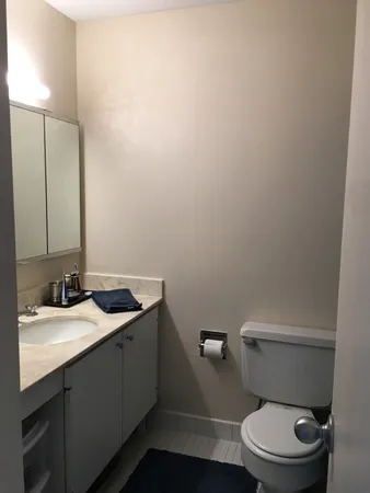 a bedroom with a bed and chair