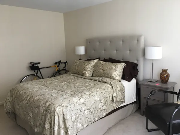 a bedroom with a bed and a book shelf