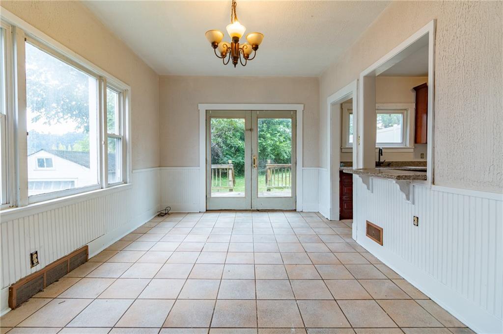 349 Orchard Street Springdale, PA 15144 - Photo 11 of 27 a view of a kitchen with a dishwasher cabinets and a large window