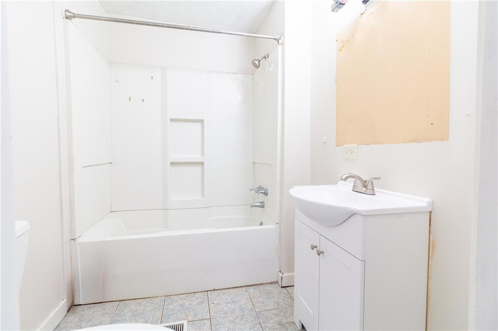 349 Orchard Street Springdale, PA 15144 - Photo 14 of 27 a bathroom with a sink and a bathtub