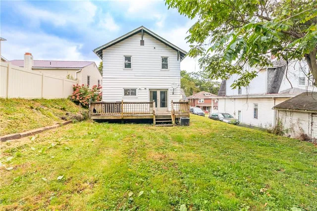 a view of a house with a yard and sitting area