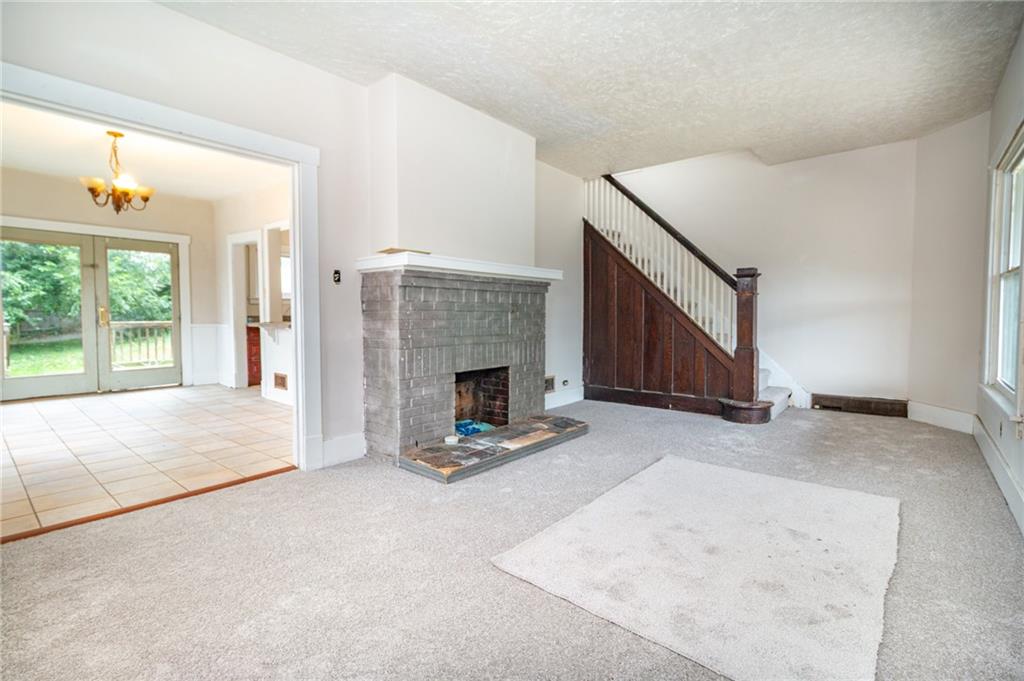 349 Orchard Street Springdale, PA 15144 - Photo 5 of 27 a view of a livingroom with a fireplace and window