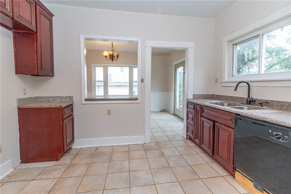 349 Orchard Street Springdale, PA 15144 - Photo 7 of 27 a spacious bathroom with a granite countertop sink a mirror and a vanity