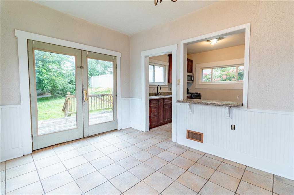 349 Orchard Street Springdale, PA 15144 - Photo 9 of 27 a view of a kitchen with kitchen island and windows