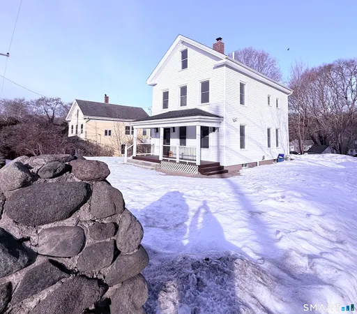 a front view of a house with a yard and trees