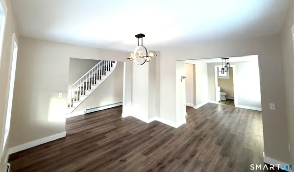 a view of entryway and hall with wooden floor