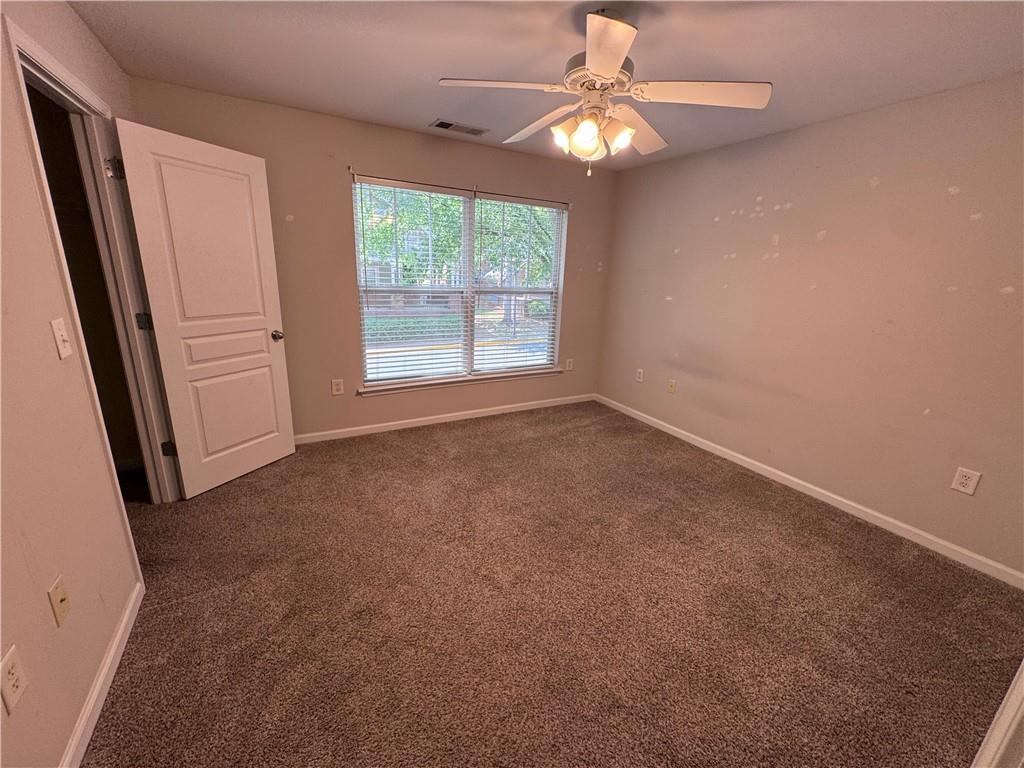 490 South Barnett Shoals Road, Unit 920 Athens, GA 30605 - Photo 8 of 19 an empty room with windows and fan
