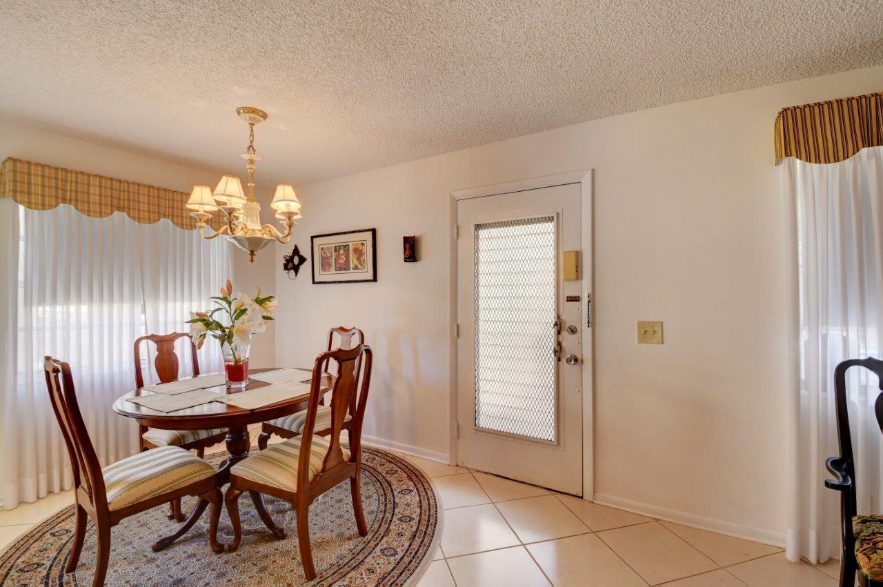 369 Capri H Delray Beach, FL 33484 - Photo 12 of 25 a dining room with furniture and chandelier kitchen view
