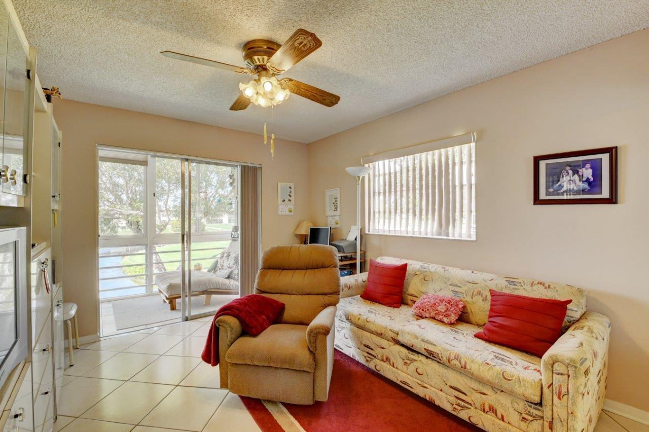 369 Capri H Delray Beach, FL 33484 - Photo 18 of 25 a living room with furniture and a large window