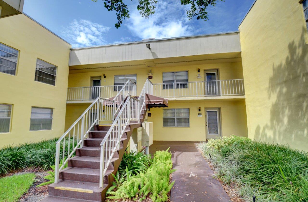 369 Capri H Delray Beach, FL 33484 - Photo 21 of 25 a front view of a house with a yard