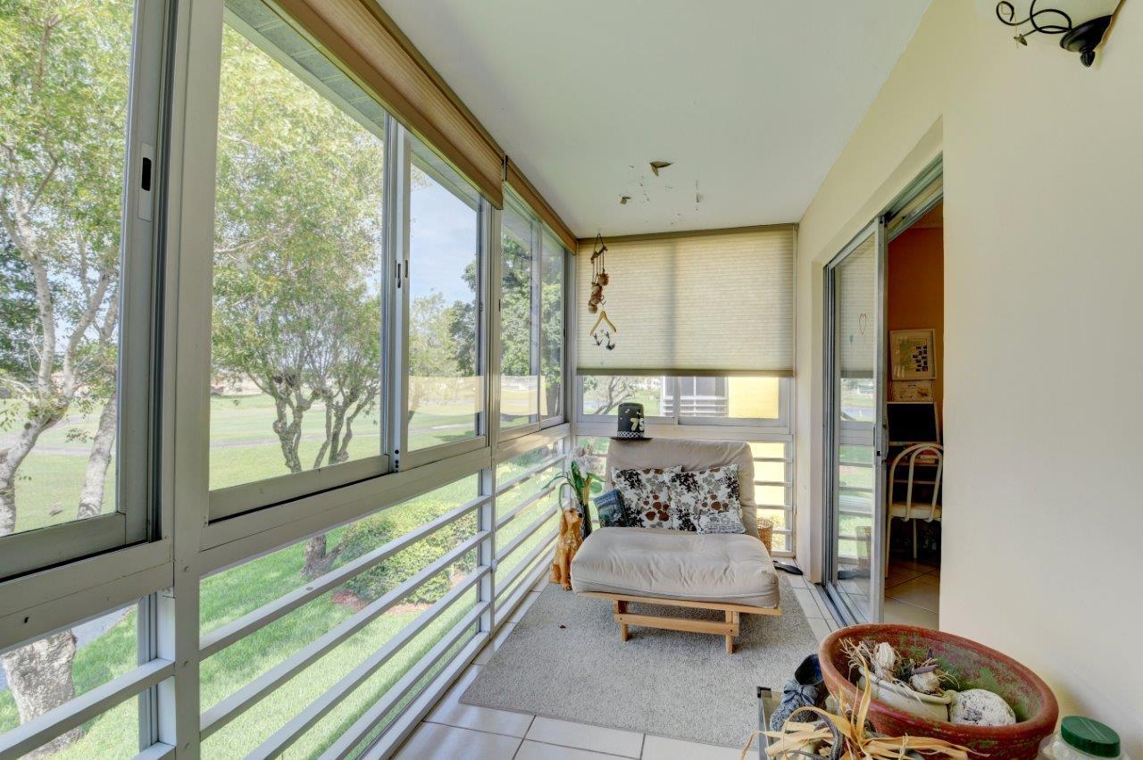 369 Capri H Delray Beach, FL 33484 - Photo 4 of 25 a bedroom with furniture and large windows