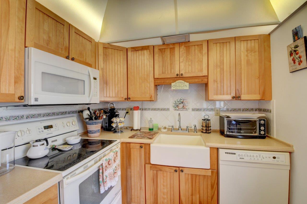 369 Capri H Delray Beach, FL 33484 - Photo 5 of 25 a kitchen with a sink stove and cabinets