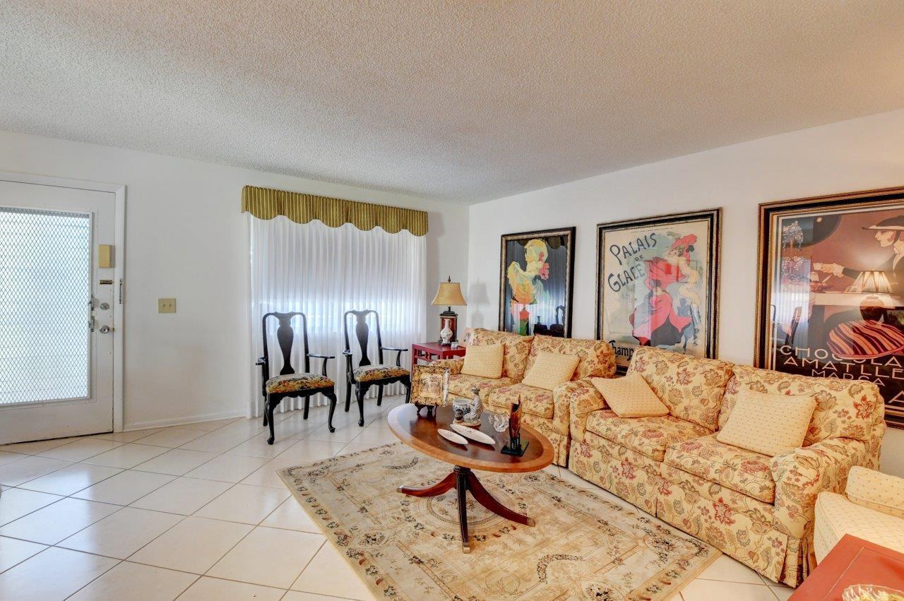 369 Capri H Delray Beach, FL 33484 - Photo 10 of 25 a living room with furniture and painting on the wall