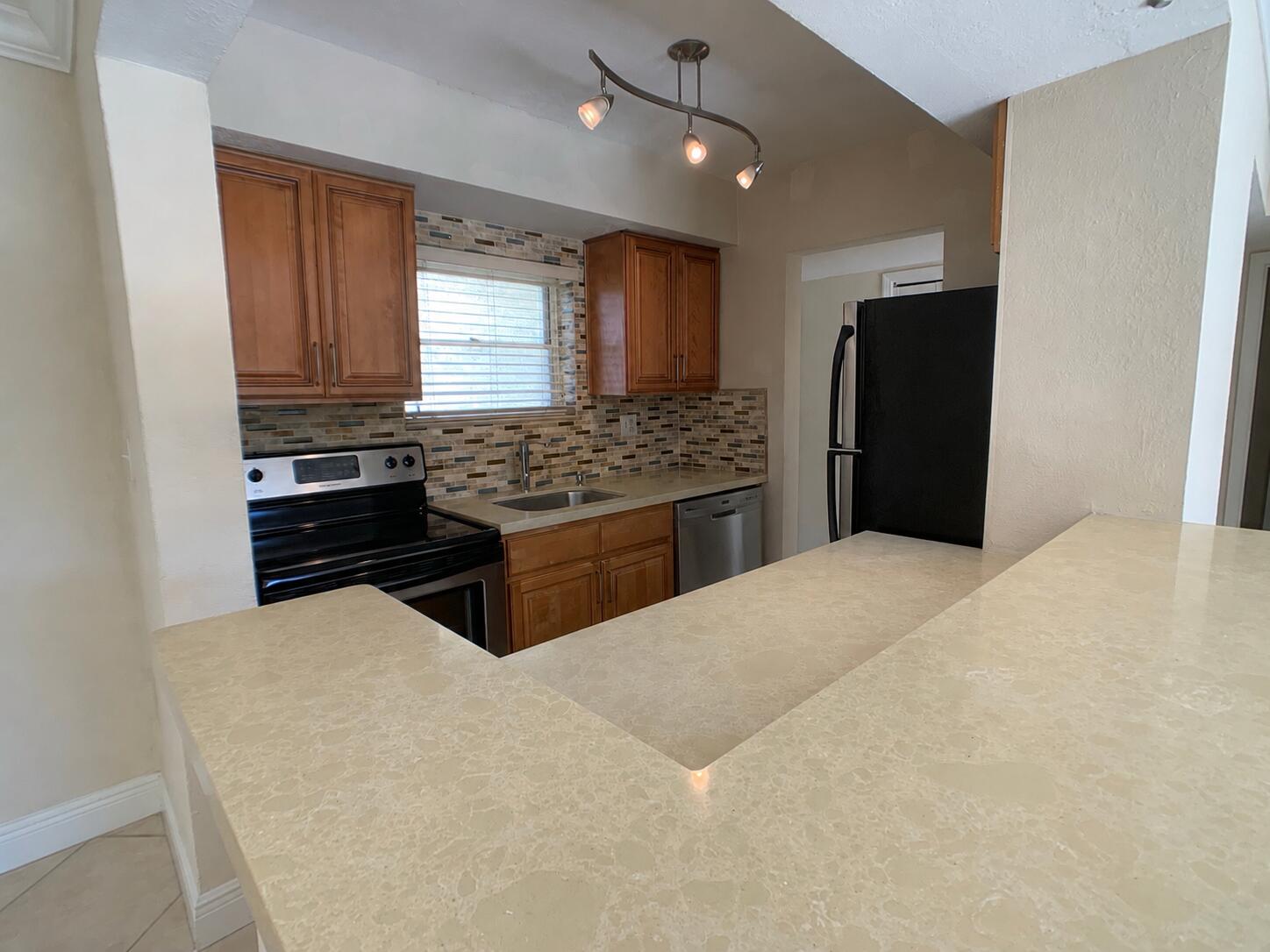 8601 Southwest 94th Street, Unit 201W Miami, FL 33156 - Photo 2 of 14 a kitchen with stainless steel appliances a refrigerator and a stove