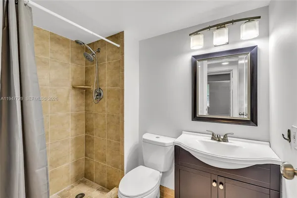a bathroom with a sink toilet and shower