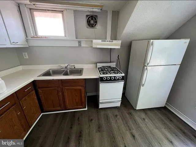 a kitchen with a refrigerator and a sink