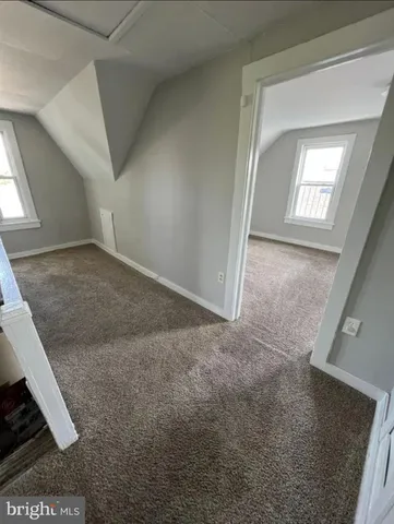 a view of kitchen with sink a refrigerator and window