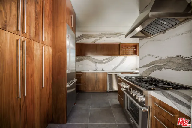 a kitchen with a stove and a refrigerator