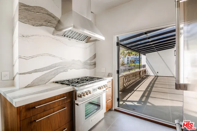 a kitchen with stove and cabinets