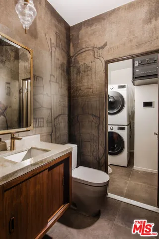 a bathroom with a sink a toilet and a mirror