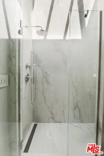 a bathroom with a shower and mirror