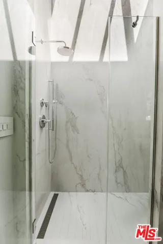 a bathroom with a shower and mirror