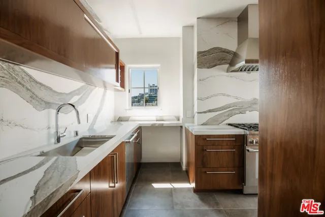 a kitchen with granite countertop a sink and a stove