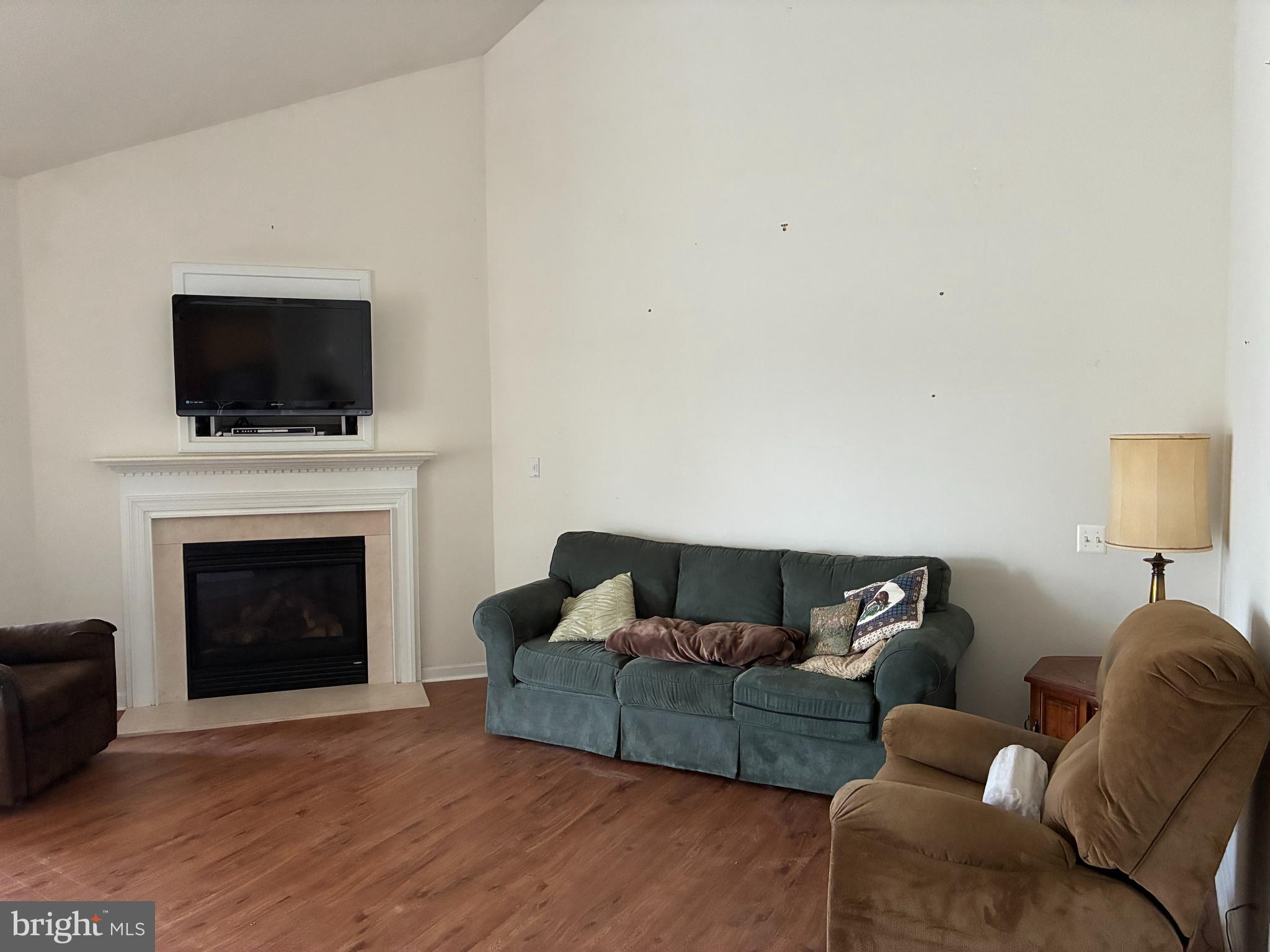 34825 Capstan Lane Lewes, DE 19958 - Photo 12 of 24 a living room with furniture a flat screen tv and a fireplace