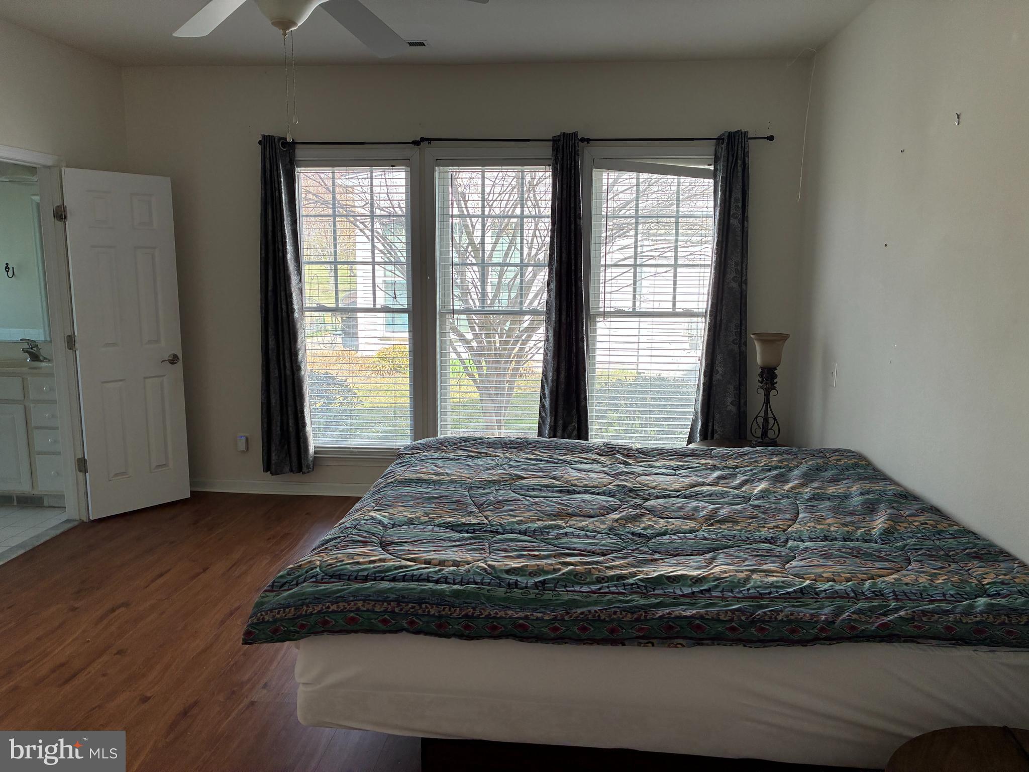 34825 Capstan Lane Lewes, DE 19958 - Photo 14 of 24 a bed sitting in a bedroom next to a window
