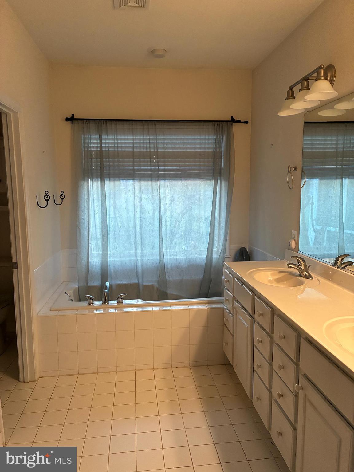 34825 Capstan Lane Lewes, DE 19958 - Photo 15 of 24 a bathroom with a tub sink and mirror