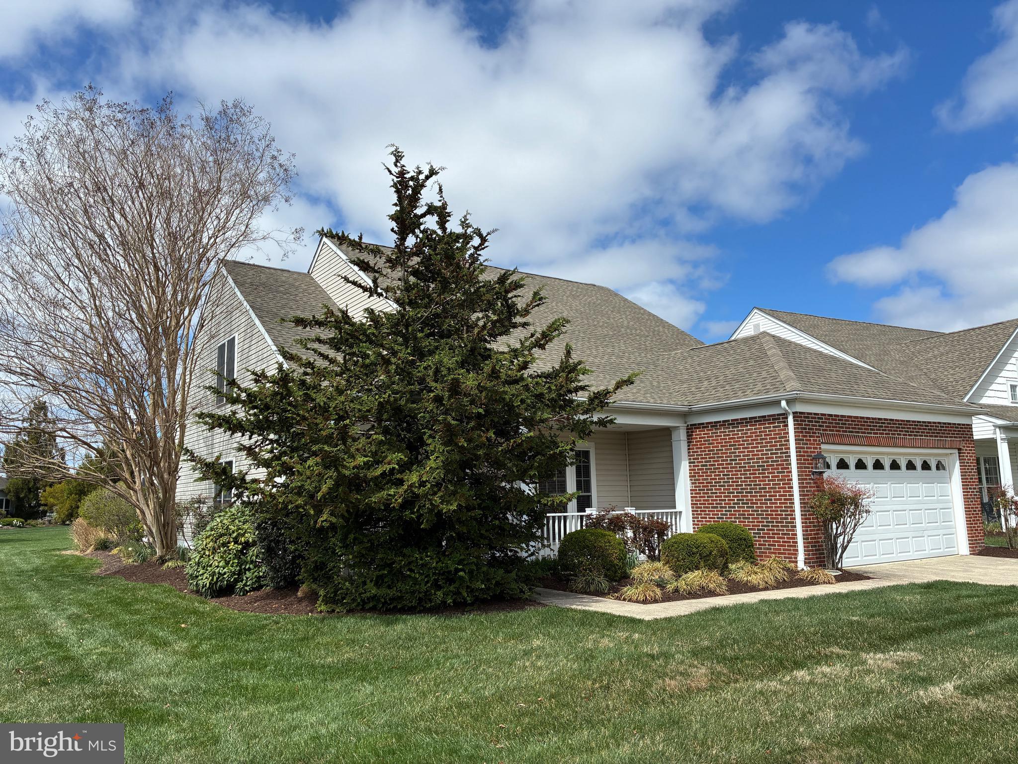 34825 Capstan Lane Lewes, DE 19958 - Photo 2 of 24 a front view of a house with a garden and yard