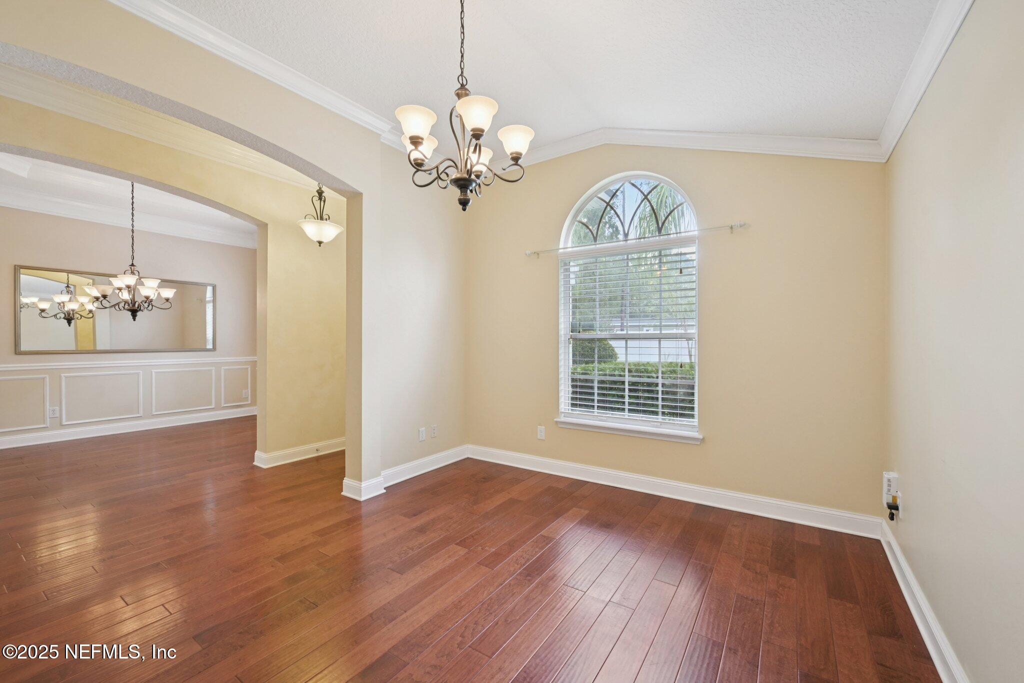 1734 Covington Lane Fleming Island, FL 32003 - Photo 12 of 54 a view of a room with wooden floors and chandelier