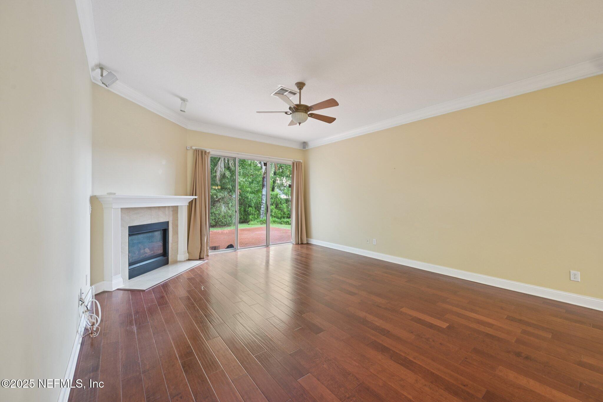 1734 Covington Lane Fleming Island, FL 32003 - Photo 14 of 54 a view of an empty room with a fireplace and a window