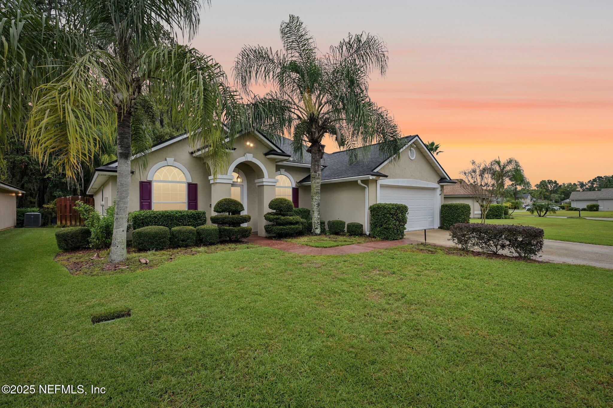 1734 Covington Lane Fleming Island, FL 32003 - Photo 2 of 54 a front view of a house with garden