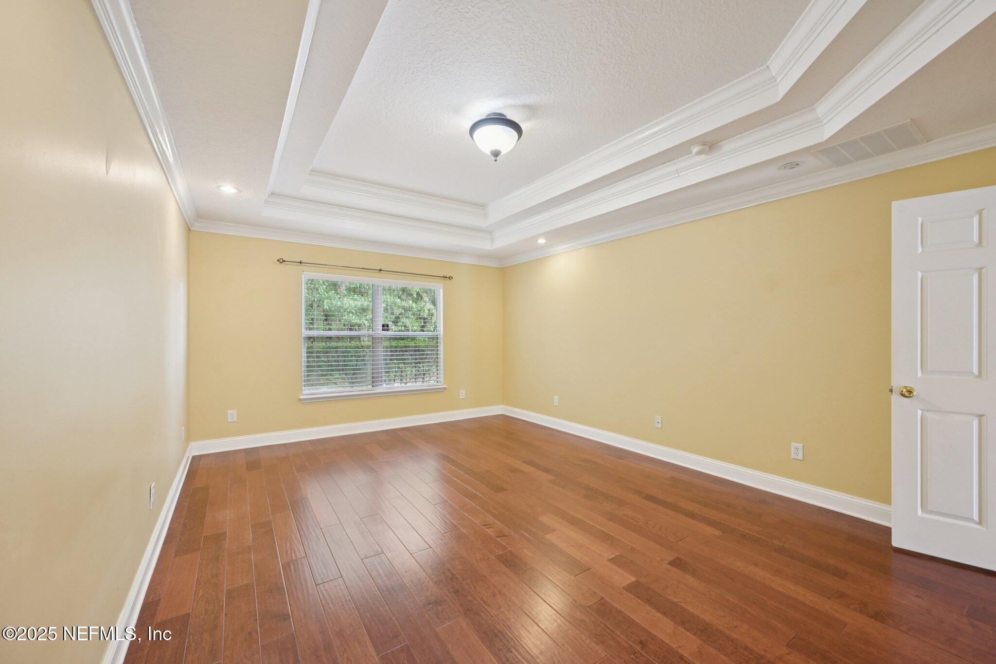 1734 Covington Lane Fleming Island, FL 32003 - Photo 24 of 54 a view of an empty room with wooden floor and a window