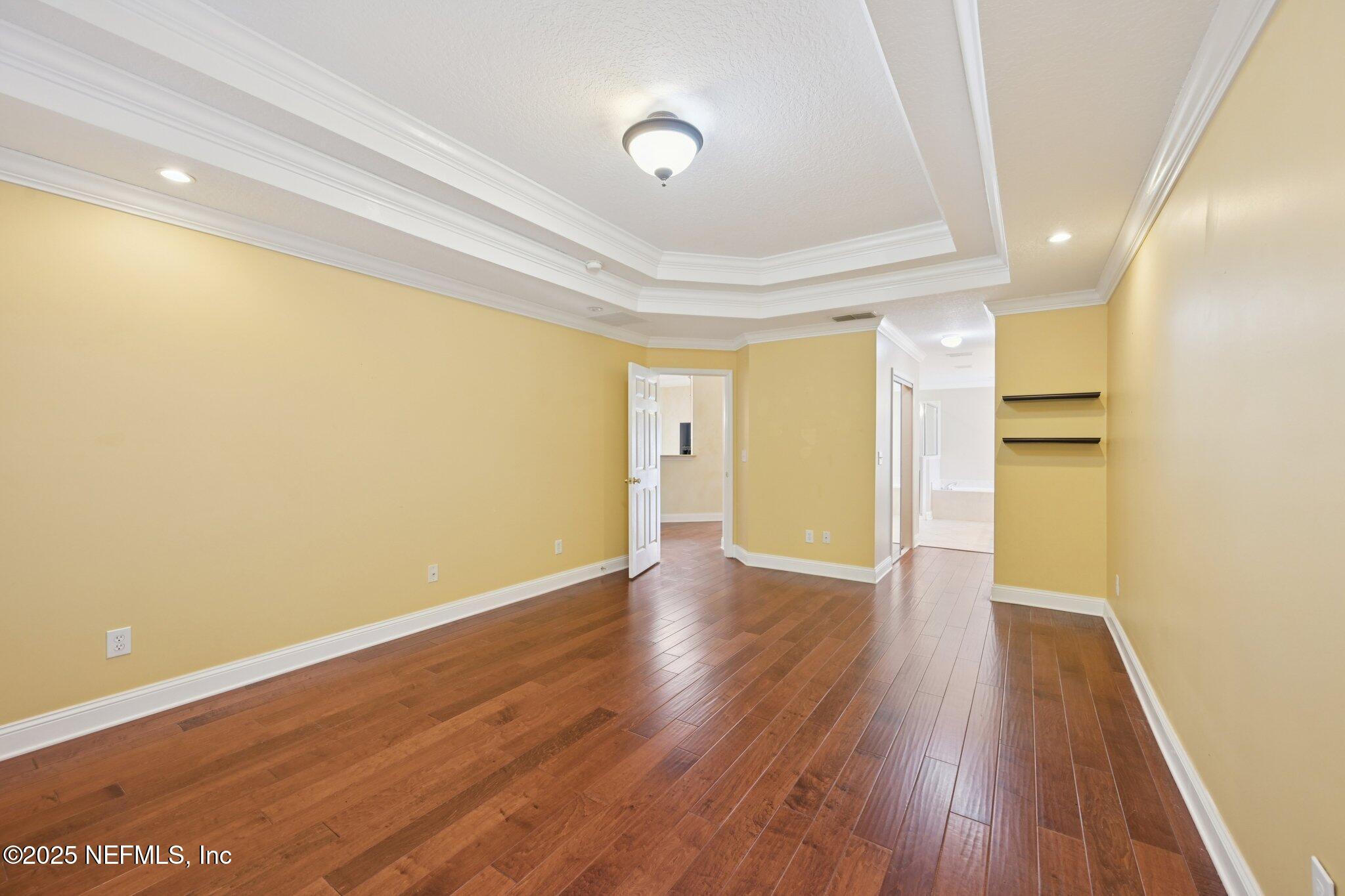1734 Covington Lane Fleming Island, FL 32003 - Photo 25 of 54 a view of an empty room with wooden floor