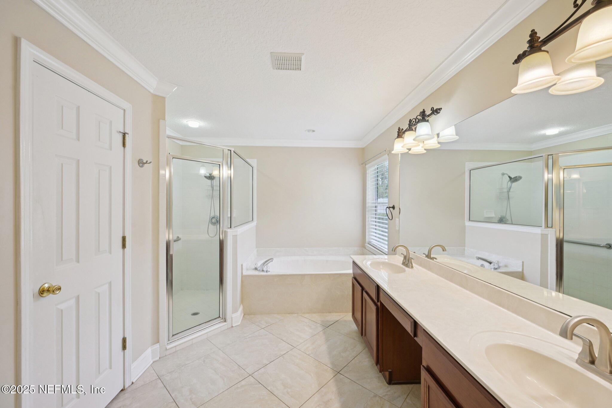 1734 Covington Lane Fleming Island, FL 32003 - Photo 27 of 54 a spacious bathroom with a tub sink shower and mirror