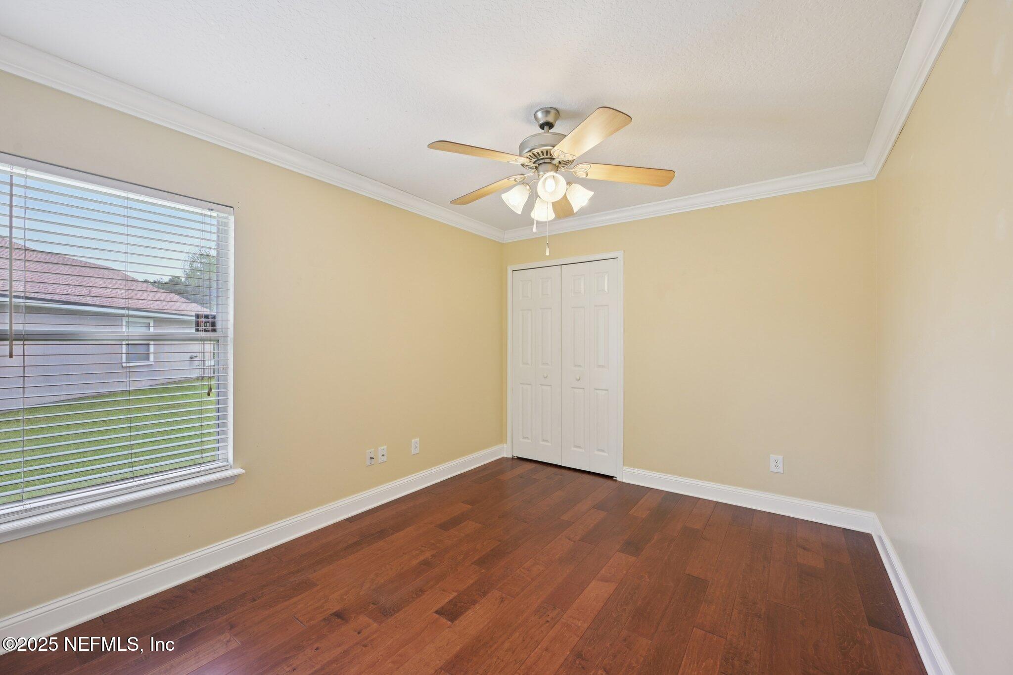 1734 Covington Lane Fleming Island, FL 32003 - Photo 29 of 54 a view of an empty room with a window and wooden floor
