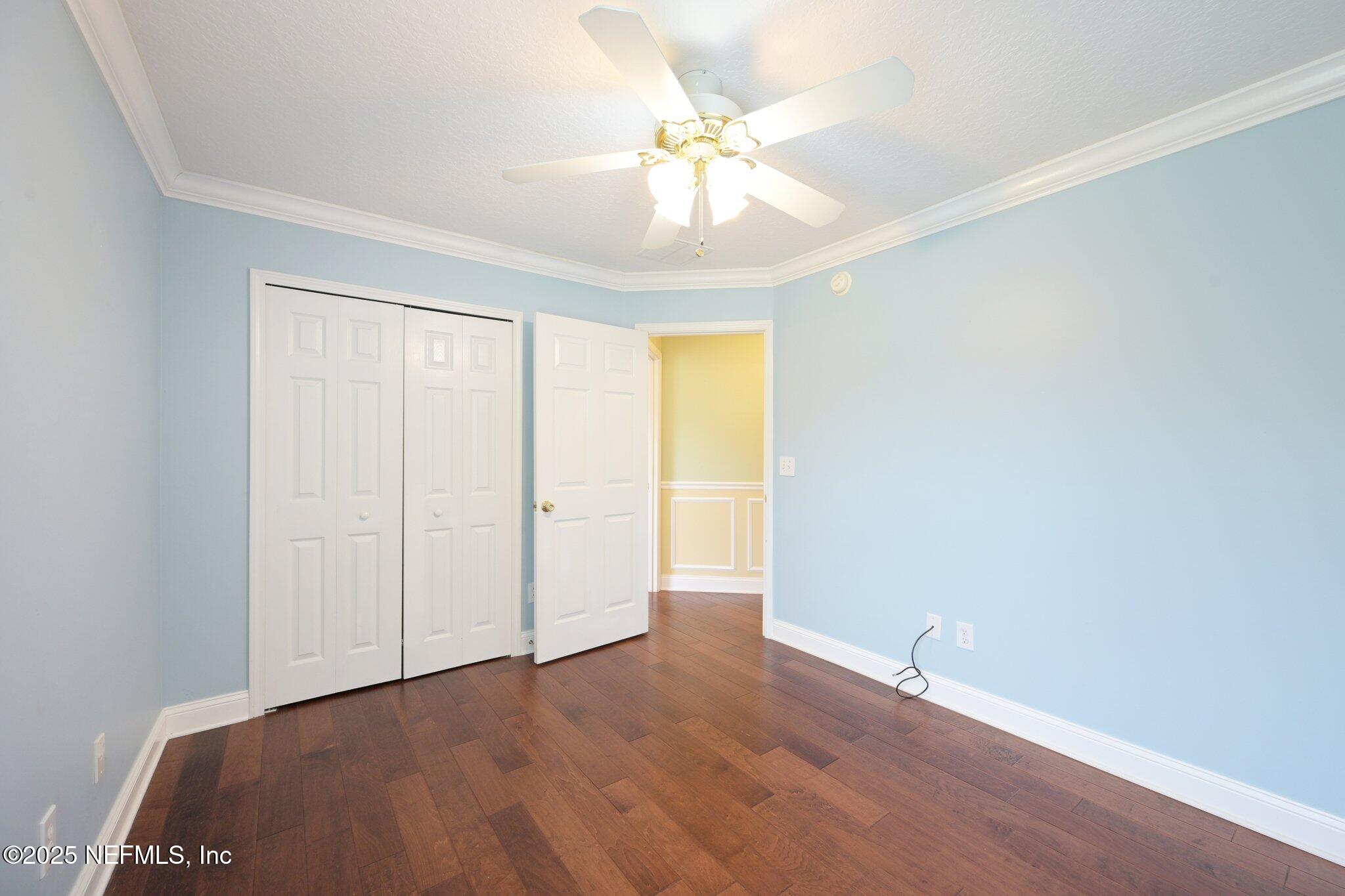 1734 Covington Lane Fleming Island, FL 32003 - Photo 32 of 54 an empty room with a chandelier fan and windows