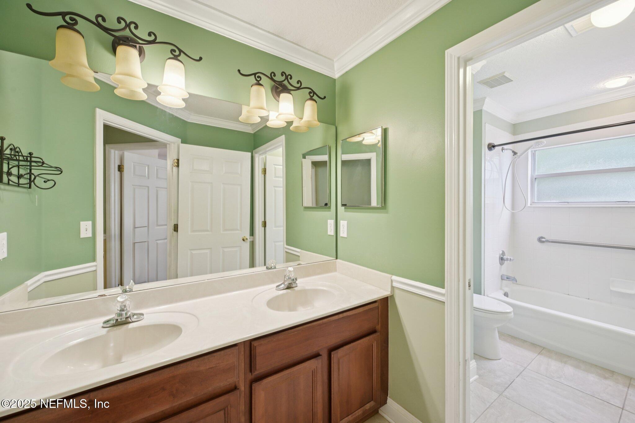 1734 Covington Lane Fleming Island, FL 32003 - Photo 34 of 54 a bathroom with a sink double vanity and a mirror