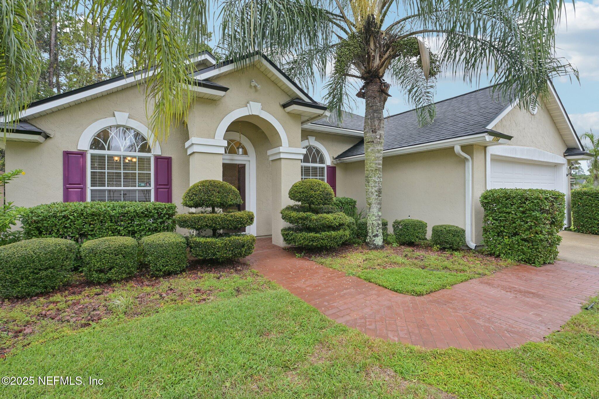 1734 Covington Lane Fleming Island, FL 32003 - Photo 4 of 54 a front view of a house with a yard