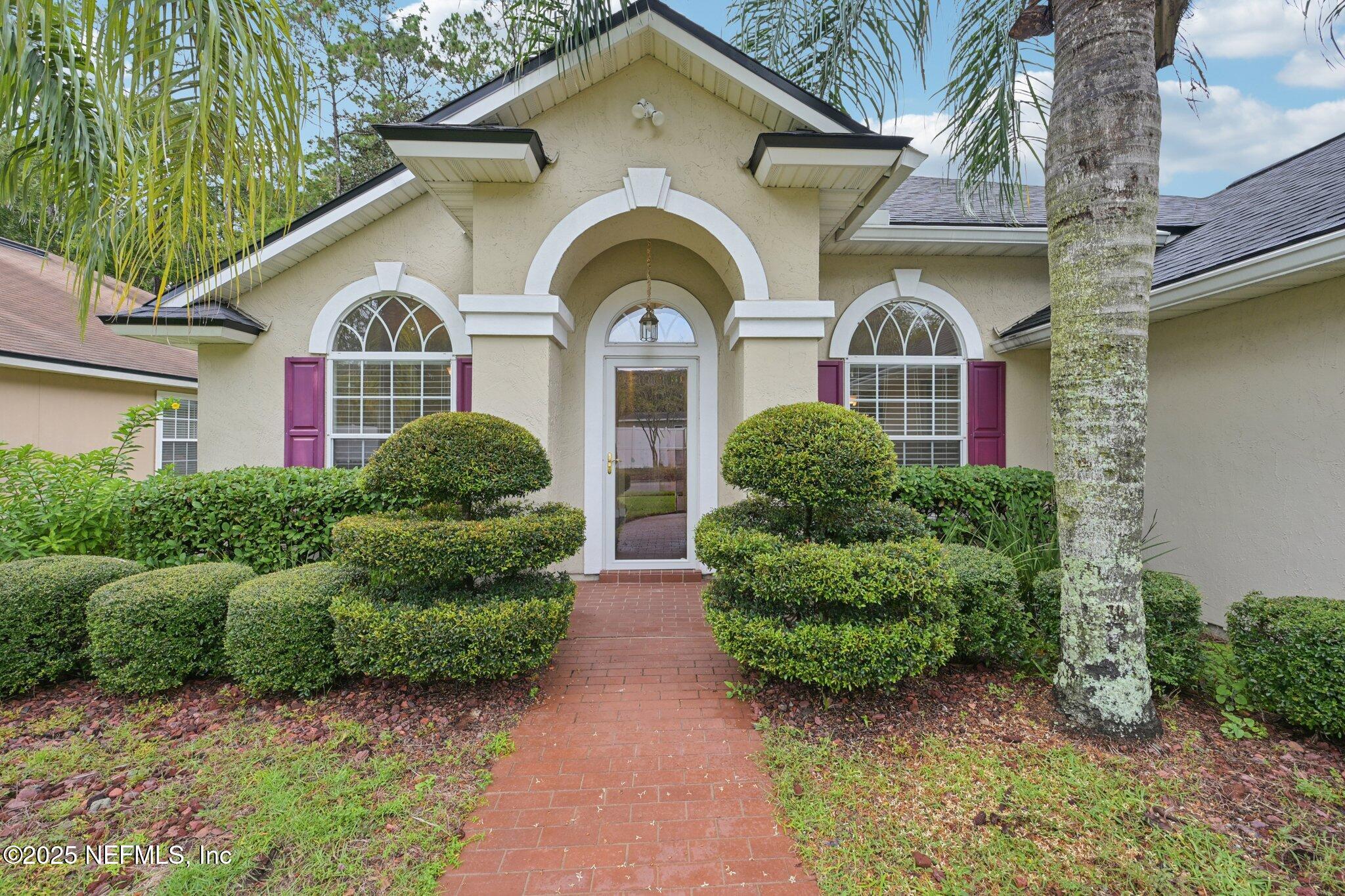 1734 Covington Lane Fleming Island, FL 32003 - Photo 5 of 54 a front view of a house with garden