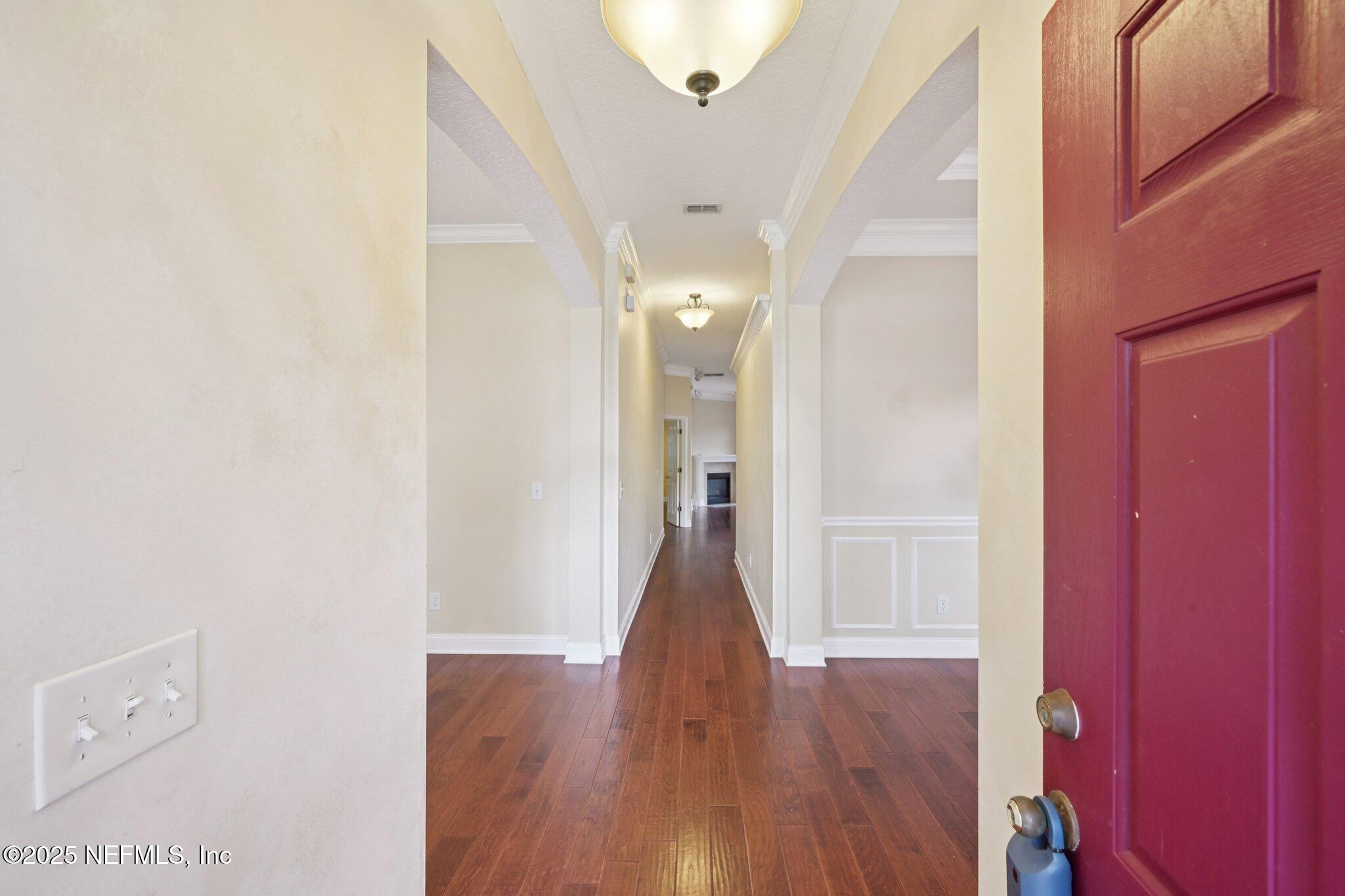 1734 Covington Lane Fleming Island, FL 32003 - Photo 6 of 54 a view of a hallway with wooden floor