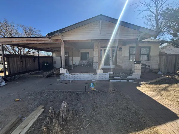 a view of a house with backyard stove and sitting area